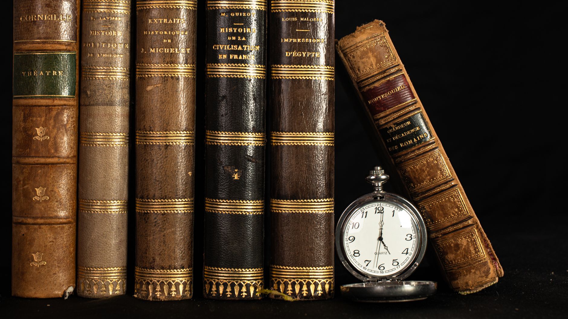 vintage books and pocket watch still life