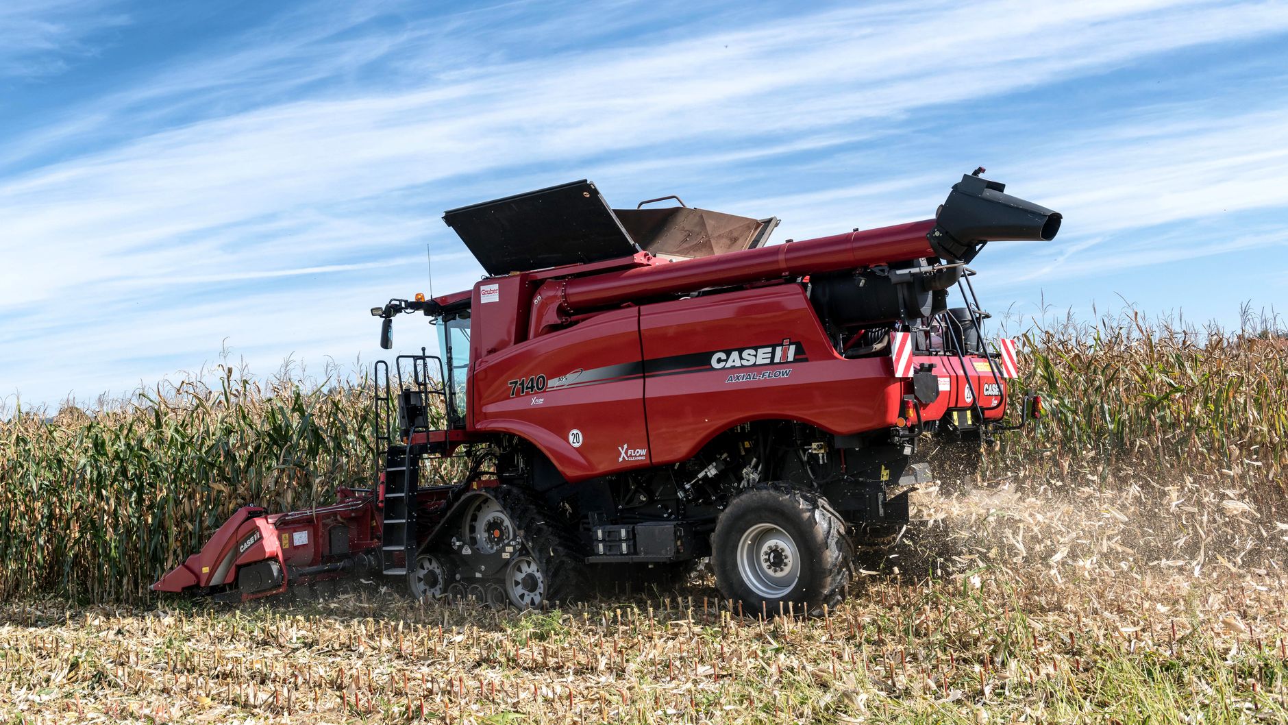 a combine harvester harvesting corn