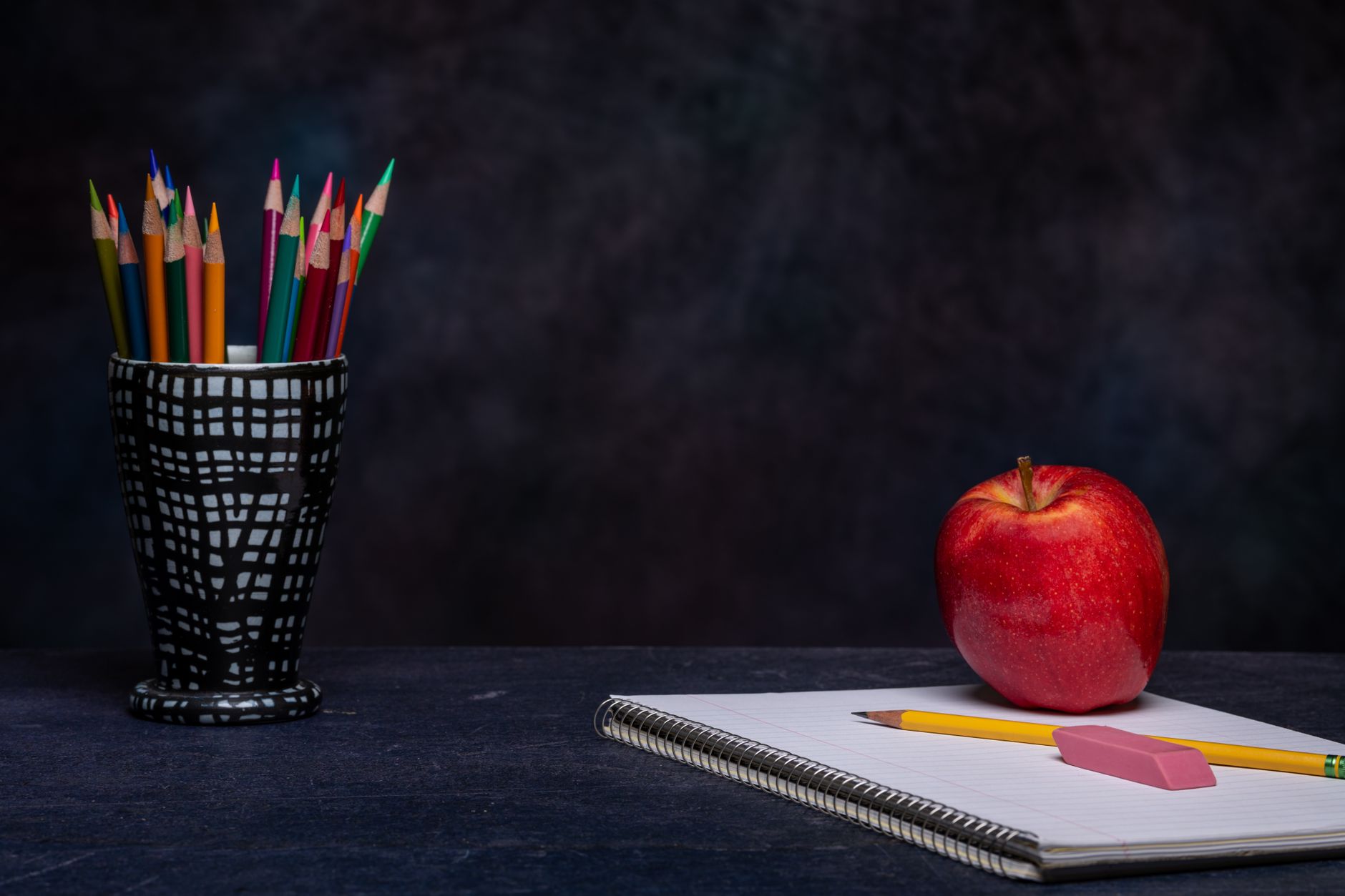 colored pencils on table with notebook
